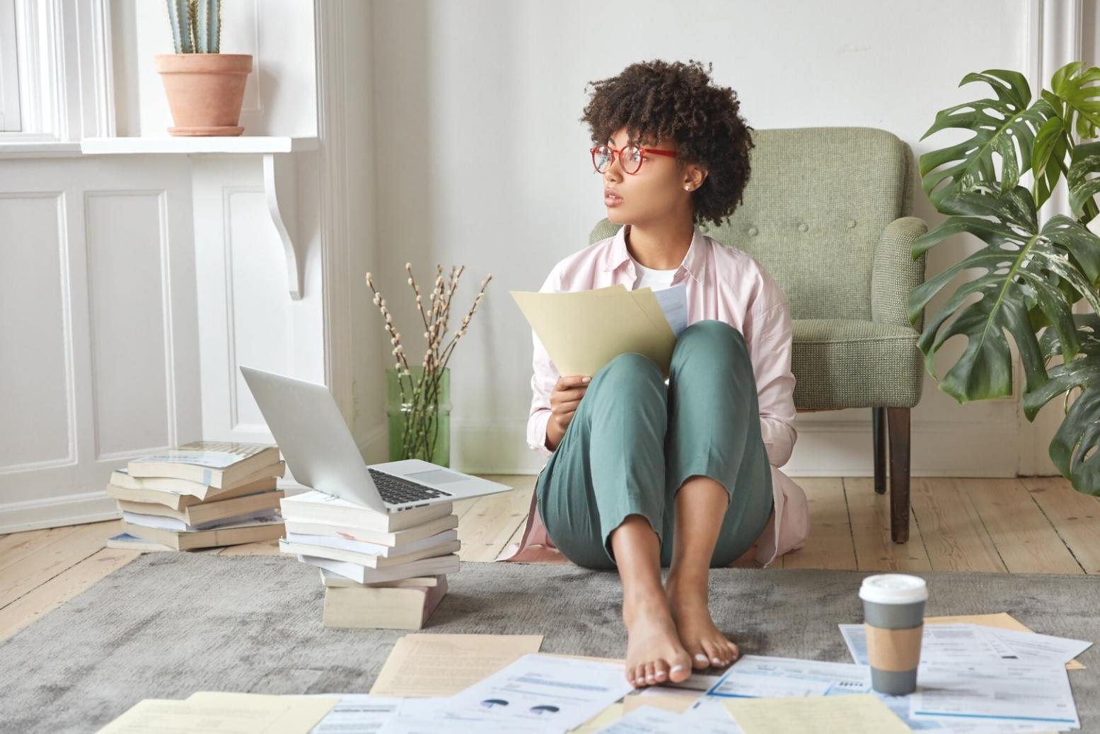 Financial analysis workspace with documents and laptop